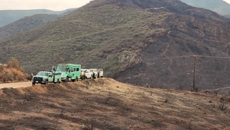 Emergency-service-vehicles-on-the-roadside-of-barren-burned-landscape-of-Fairview-Fire-California