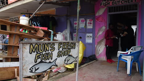 People-buy-fresh-fish-at-a-market-butchery-in-Kilifi,-near-Mombasa-Town,-Kenya