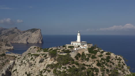 Aerial-orbit-shot-of-Cap-de-Formentor-lighthouse-during-hot-summer-day