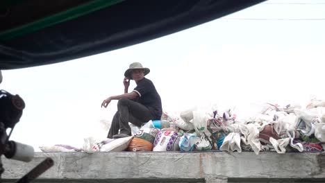 Pescador-Sentado-En-Un-Muelle-Sentado-Sobre-Un-Montón-De-Basura