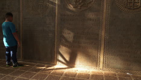 African-child-captivated-by-tombstones-at-Saint-Paul-Church,-Malacca