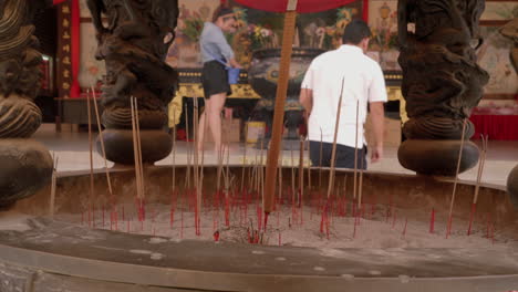 Asian-man-offering-incense-stick-in-Thean-Hou-Temple,stable-shot