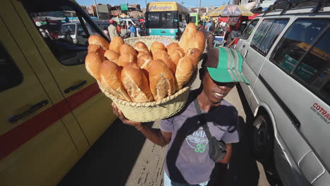 Malagasy-Local-Selling-Baguette-Rolls-On-Busy-Street-In-Antananarivo,-Madagascar