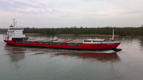 Finnish-containership-Marjatta-sailing-across-the-Oude-Mass-river,-Zwijndrecht,-Netherland