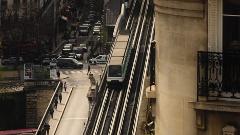 Overground-Metro-train-in-Paris-on-a-bridge,-filmed-in-cinematic-slow-motion-at-high-angle