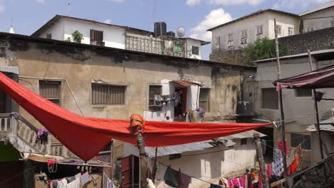 Large-Red-Fabric-Drying-In-Courtyard-In-Zanzibar