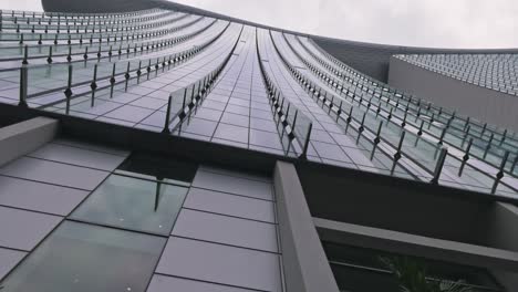 Looking-Up-At-Curve-Of-Marina-Bay-Sands-Hotel-Building-In-Singapore