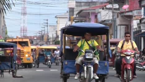 View-Looking-Down-Busy-Intersection-Road-With-Traffic-In-Iquitos,-Peru