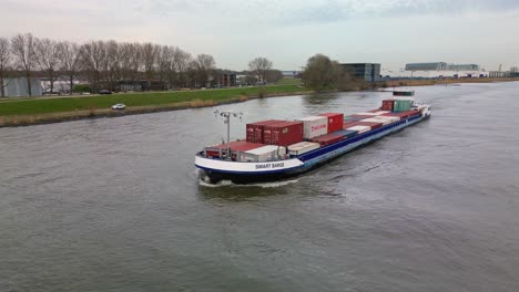 Container-ship-Smart-Barge-sailing-through-the-river-of-Zwijndrecht,-South-Holland