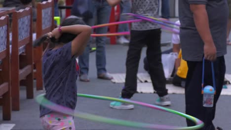Young-Female-Child-Hula-Hooping-On-Bagdad-Street-In-Singapore