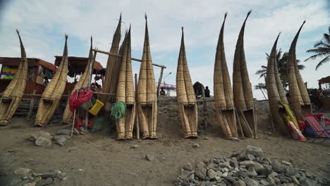 Row-Of-Standing-Caballitos-Inca-Reed-Boats-On-Beach-In-Peru