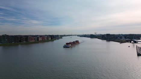 Drone-Shot-Of-Large-Aquapolis-Cargo-Ship-Sailing-In-Drodrecht-River,-Netherlands