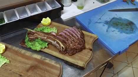 Chef-Preparing-Cooked-Rib-Eye-Steak-On-Kitchen-Counter-Carefully