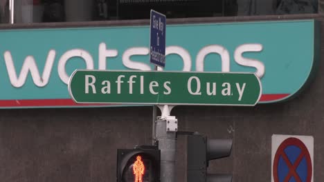 Raffles-Quay-Road-Sign-On-Top-Traffic-Lights-In-Singapore