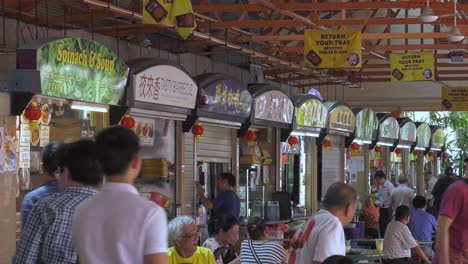 Busy-Hawker-Food-Centre-in-the-middle-of-business-district,-Singapore---Wide-static-shot