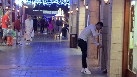 Local-Egyptian-worker-is-cleaning-street-on-public-street-of-Soho-Square