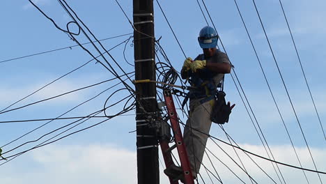 Telephone-Lineman-Fixing-Up-Communications-Cable.-Locked-Off