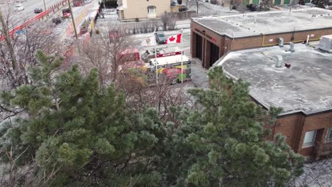 Aerial,-fire-trucks-with-black-history-month-decoration-parked-at-Canadian-fire-station