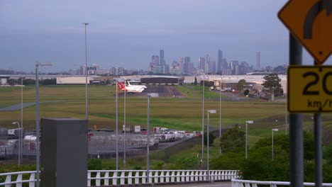 Static-shot-at-Brisbane-international-airport-capturing-Qantas-aircrafts-parked-at-the-airport-apron-with-Brisbane-city-downtown-cityscape-on-the-skyline,-Queensland,-Australia