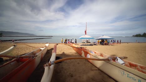 View-from-Nautical-Vessels-resting-on-the-sand-beach-to-the-Ocean-front-in-Oahu,-Hawaii---Panning-left-to-right-wide-shot