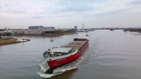 Finnish-containership-Marjatta-sailing-across-the-river,-Zwijndrecht,-Netherland