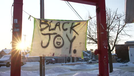 A-Black-Joy-flag-hangs-outside-the-location-where-George-Floyd-was-killed-by-police-officers-in-May-2020-in-Minneapolis,-Minnesota