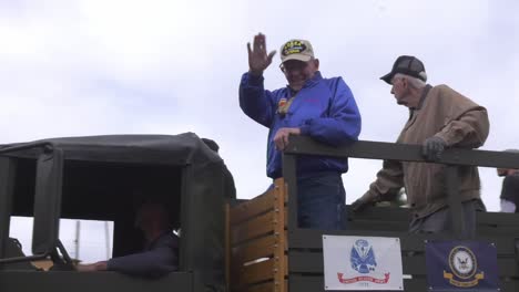 Military-Veterans-Waving-To-Spectators-From-Back-Of-Truck-In-Parade-In-Arizona