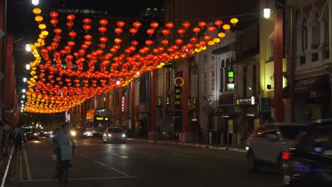 Overhead-traditional-Chinese-lanterns-covering-busy-road-in-Singapore---Wide-static-shot