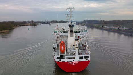 Finnish-containership-Marjatta-sailing-across-the-Oude-Mass-river-under-beautiful-sunset-sky