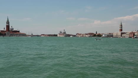 Venetian-lagoon-with-city-buildings-in-the-background-in-Venice,-Italy