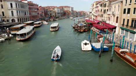 Venetian-small-size-boat-riding-in-the-Grand-Canal-in-Venice,-Italy