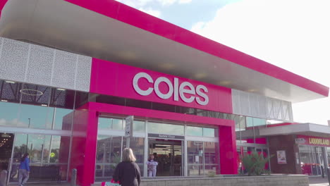 Downward-camera-tilt-capturing-the-steady-stream-of-customers-entering-the-Coles-store
