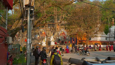 Cityscape-view-of-a-crowd-of-people-walking-near-temples-and-shrines,-in-Kathmandu,-Nepal