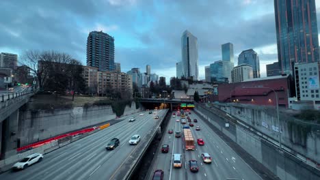 Seattle-traffic-over-the-the-highway-with-a-view-of-the-skyline---aerial