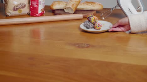 revealing-shot-of-plate-with-oatmeal-balls-sliding-on-countertop