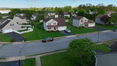 Aerial-zoom-in-on-family-home-in-quiet-suburban-neighborhood