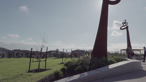 The-camera-sweeps-across-the-new-playground-on-a-sunny-afternoon,-showcasing-people-of-all-ages-having-a-wonderful-time,-immersing-themselves-in-the-fun-filled-environment