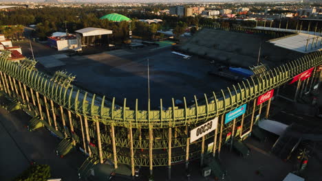 Aerial-view-backwards-away-from-the-Foro-Sol-Venue-and-the-Autódromo-Hermanos-Rodríguez,-sunny-evening-in-Mexico-city---reverse,-drone-shot