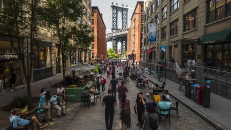 timelapse-and-motionlapse-from-Dumbo,-Manhattan-Bridge-View,-New-York-City,-daytime-with-people-visiting-and-taking-pictures-at-the-iconic-spot-with-the-bridge-in-the-background