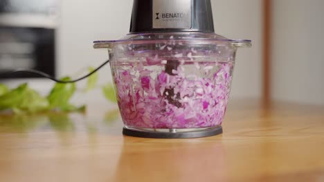 Red-onion-chopped-to-pieces-in-electric-chopper