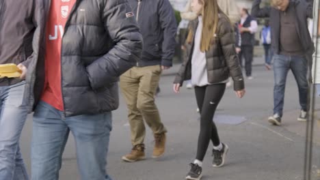 Arsenal-fans-walk-to-stadium-for-match-day-at-the-Emirates-Stadium