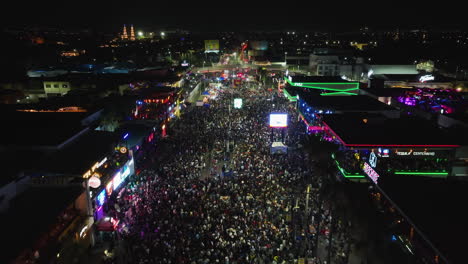 Drone-shot-over-the-night-lit-Feria-San-Marcos-fair,-in-Aguascalientes,-Mexico