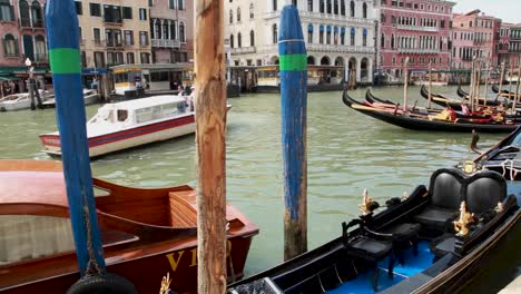Venetian-boats-and-gondolas-docking-in-a-pier-in-Venice,-Italy