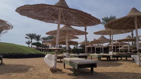 empty-beach-resort-with-wooden-beach-umbrellas