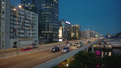 Aerial-view-tracking-traffic-on-the-illuminated-Kwun-Tong-bypass