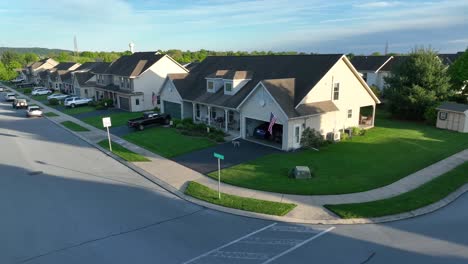 Aerial-shot-of-American-flag-waving-on-home-in-neighborhood
