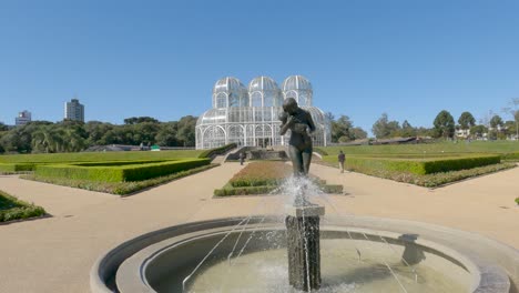 Botanical-Garden-of-Curitiba,-gardens-with-the-"Motherly-Love"-statue,-and-the-"Crystal-Palace"-greenhouse-in-art-nouveau-style