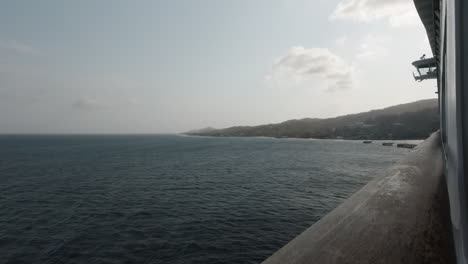Roatan,-Honduras-as-seen-from-the-balcony-of-a-cruise-ship-in-the-evening-in-slow-motion