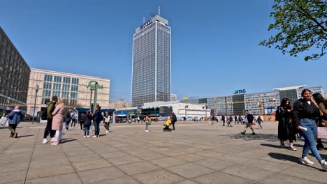 Static-shot-of-tourists-walking-across-alexanderplatz-square