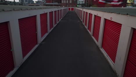 Aerial-establishing-shot-of-red-self-storage-units-at-dusk